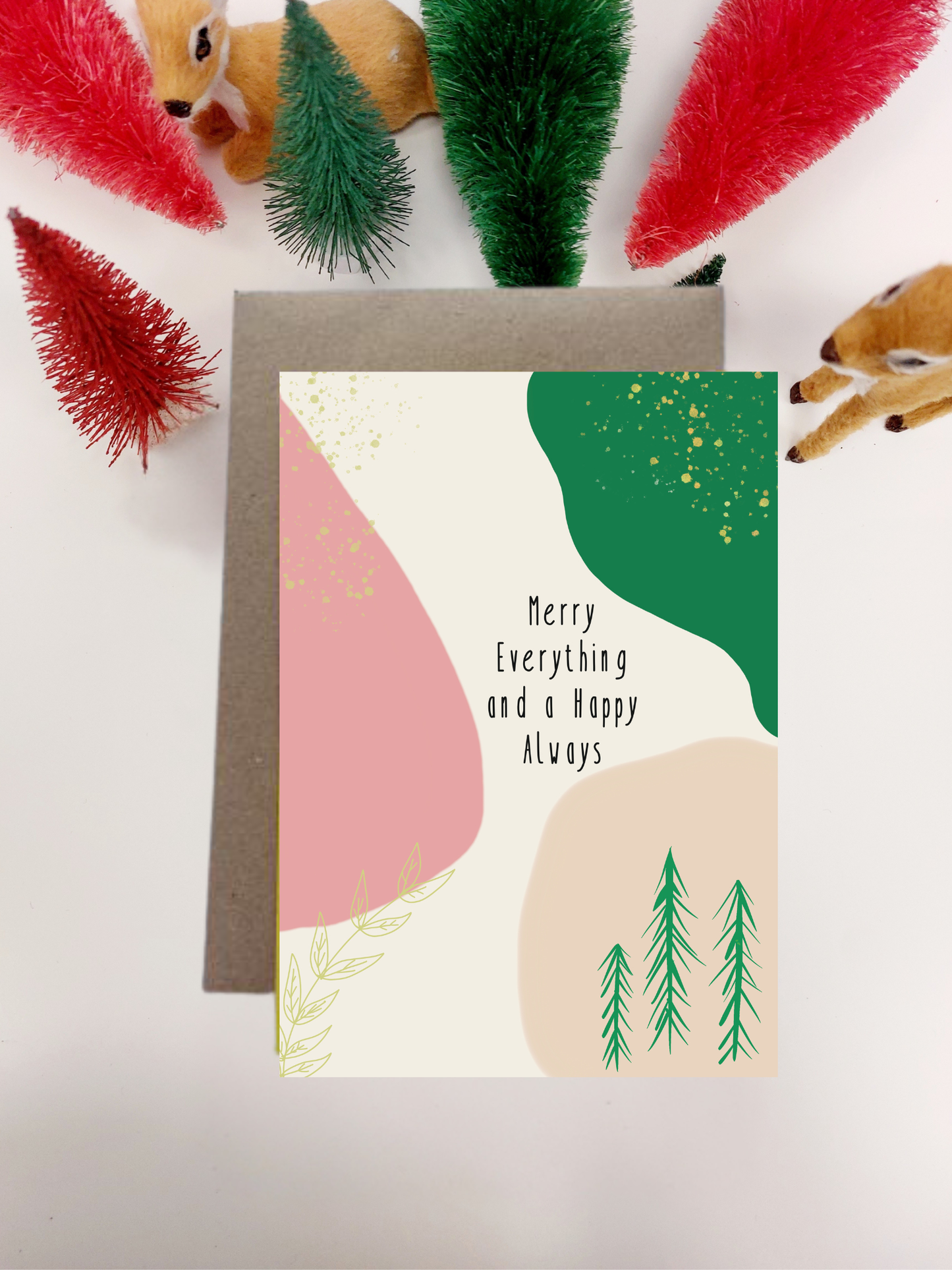 Irish Made Christmas Card with abstract design and text, surrounded by festive decorations on a light background