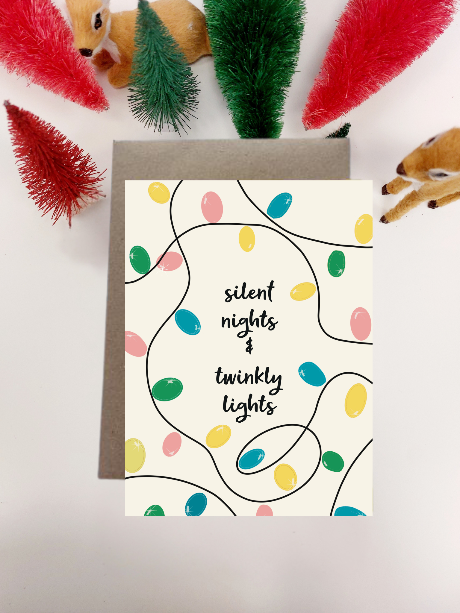 Irish Made Christmas card with colorful lights and text 'silent nights & twinky lights' on a white background.